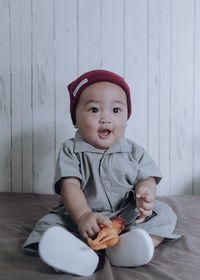 Portrait of cute baby boy sitting