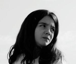 Close-up portrait of young woman against white background