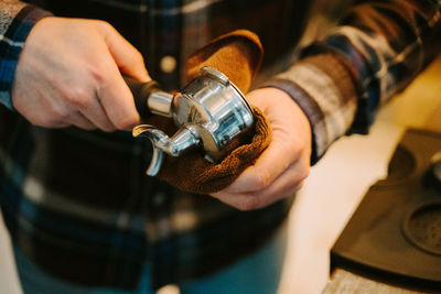 Midsection of man working with coffee