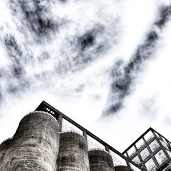 Low angle view of bridge against cloudy sky