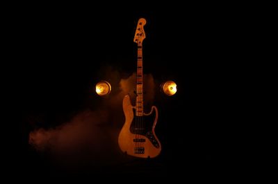 Close-up of guitar against black background