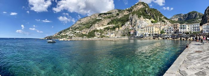 Panoramic view of sea and mountains against sky