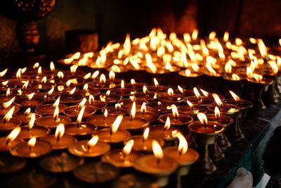 Close-up of lit candles in temple