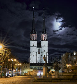 Illuminated buildings against sky at night