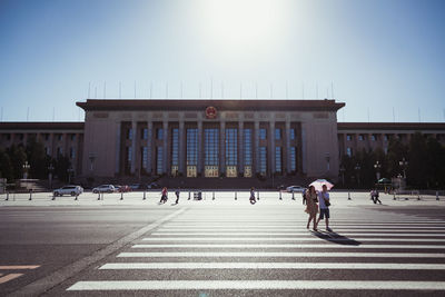 People walking in front of building