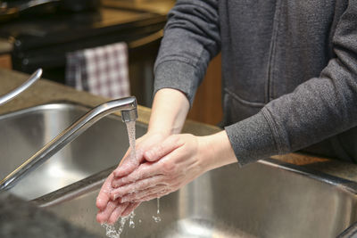 Midsection of man preparing food in kitchen