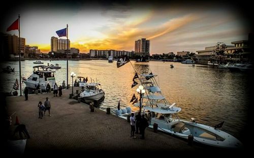 Boats in harbor at sunset