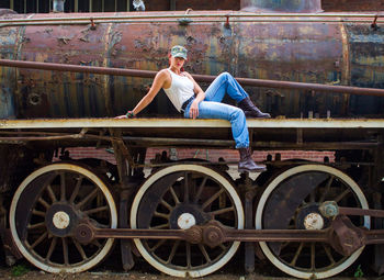 Full length of man sitting at train