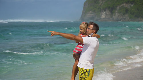 Happy father with daughter on tropical beach during summer vacation. bali. 