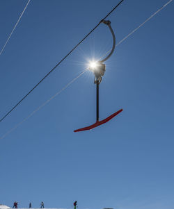 Low angle view of street light against clear blue sky