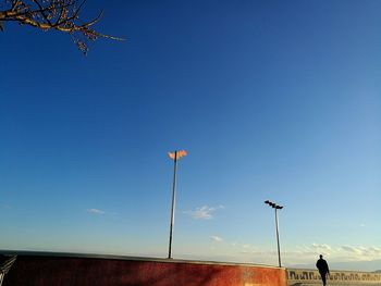 Man walking on road against sky