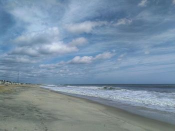 Scenic view of sea against cloudy sky