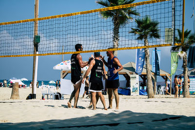 People on beach against sky