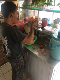 Side view of a boy holding food