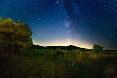Scenic view of field against sky at night