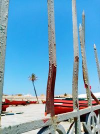 Metallic structure on beach against clear blue sky