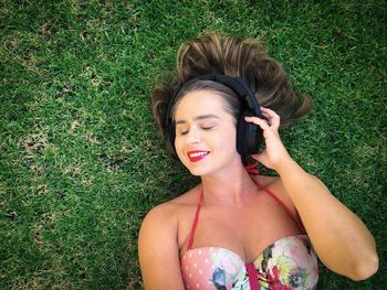 Smiling young woman lying on field