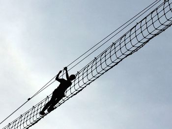 Low angle view of cables against sky