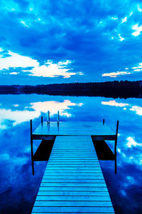 Scenic view of calm lake against blue sky