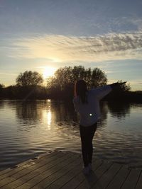 Silhouette of woman in lake