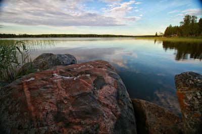 Scenic view of lake against cloudy sky