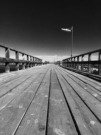 Wooden footbridge against clear sky