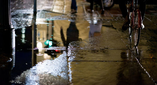 Reflection of fountain in puddle during rainy season