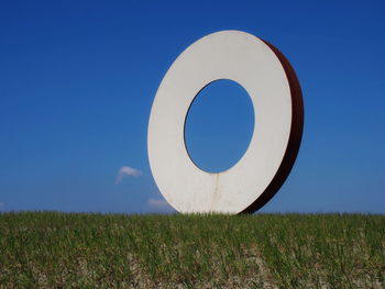 Scenic view of field against clear blue sky