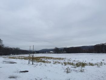 Snow covered field against sky