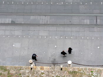 Directly above shot of people by tramway on street