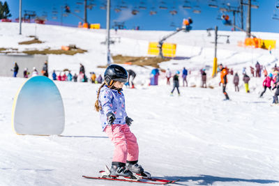 Cute girl skiing on ski resort