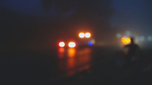 Defocused image of illuminated city at night