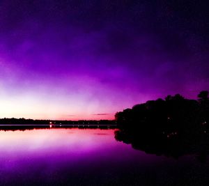 Scenic view of lake against sky at night