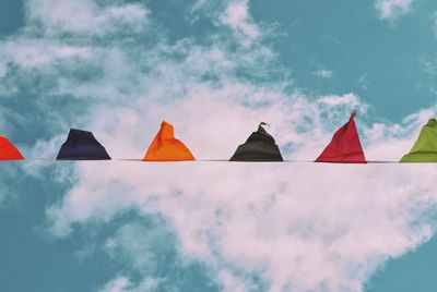 Low angle view of flags against sky