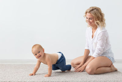 Mother playing with daughter at home