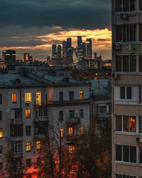 High angle view of illuminated buildings against sky at sunset