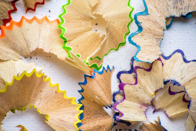 Close-up of multi colored pencil shavings on table