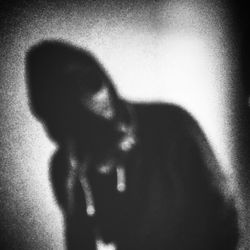 Close-up of shadow of man over white background