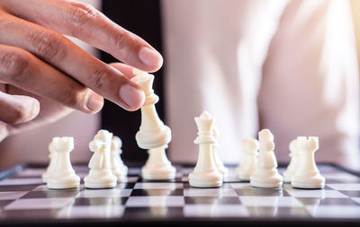 Midsection of businessman playing chess