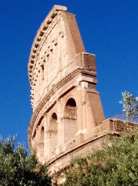 Low angle view of historical building against blue sky