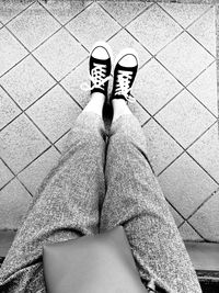 Low section of woman standing on tiled floor