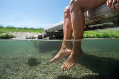 Low section of woman relaxing in lake