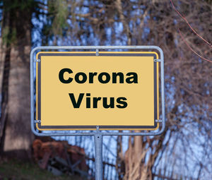 Close-up of road sign against trees