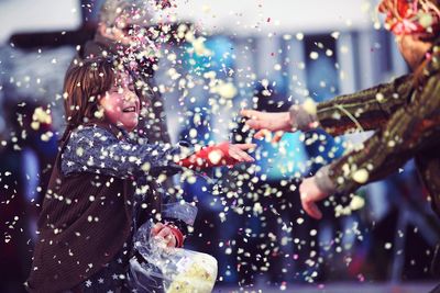 Father and daughter throwing confetti on each other