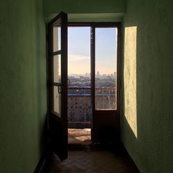 City against sky seen through window