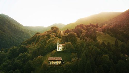 Church, trees and plants growing on mountain against sky