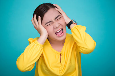 Young woman against blue background