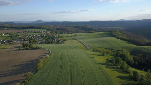 Scenic view of agricultural landscape against sky