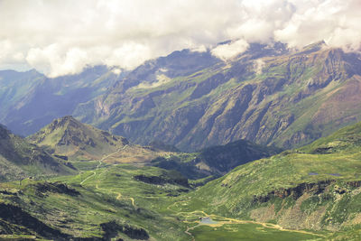 Scenic view of valley and mountains against sky