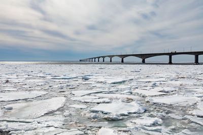 Bridge over sea against sky